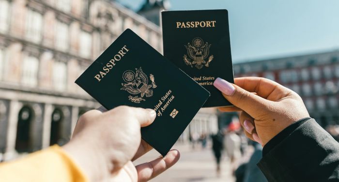 two-hands-holding-passports.jpg.optimal.jpg
