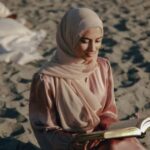 fair-skinned-woman-in-hijab-reading-on-the-beach.jpg.optimal.jpg
